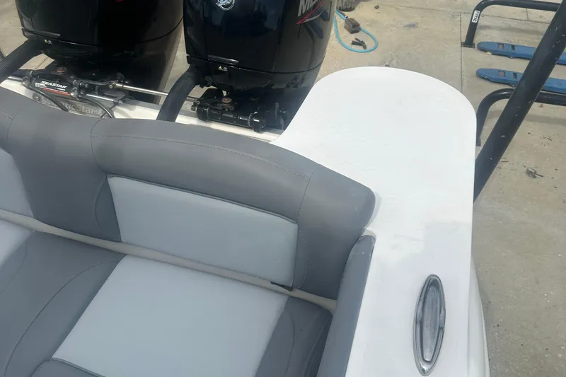 Slide: The Image of 2023 NauticStar 2602 Legacy boat with dual outboard motors and gray seating. - 40