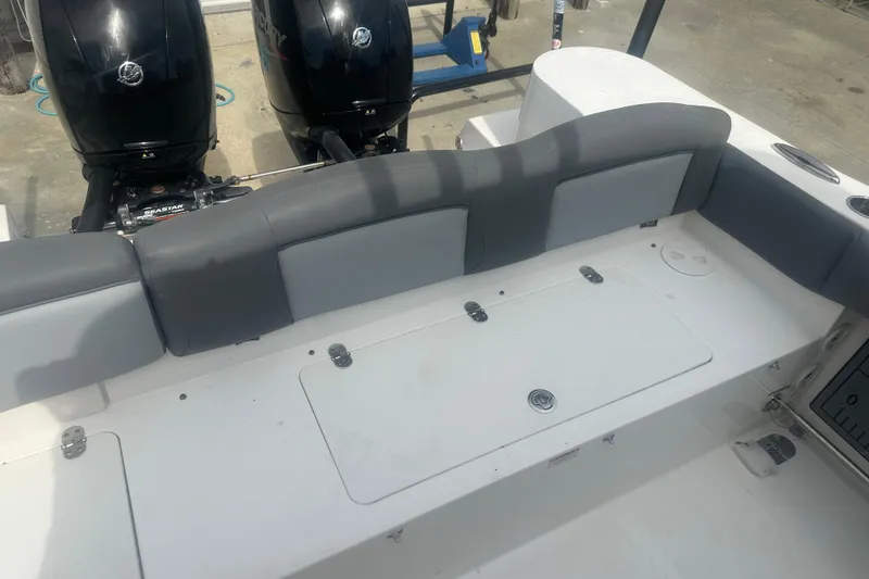 Slide: The Image of 2023 NauticStar 2602 Legacy boat interior with dual engines and cushioned seating. - 44