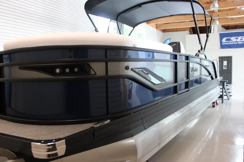 Slide: The Image of 2025 Barletta Corsa 23UC pontoon boat in showroom, featuring sleek design and modern amenities. - 10
