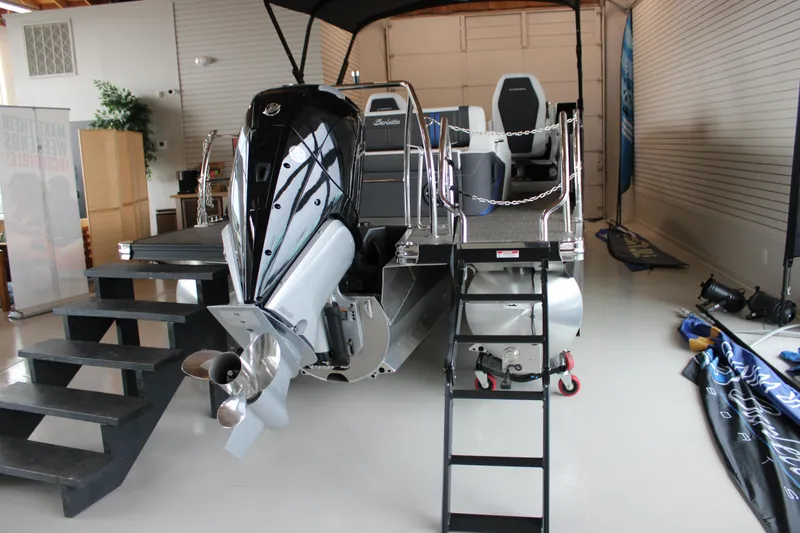 Slide: The Image of 2025 Barletta Corsa 23UC pontoon boat with outboard motor in showroom. - 13