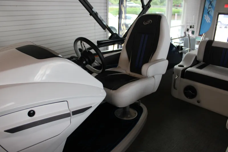 Slide: The Image of 2025 Barletta Corsa 23UC boat interior with sleek captain's chair and modern dashboard. - 21
