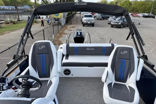 Slide: The Image of 2025 Barletta Corsa 23UC pontoon boat interior with stylish seating and steering wheel. - 27