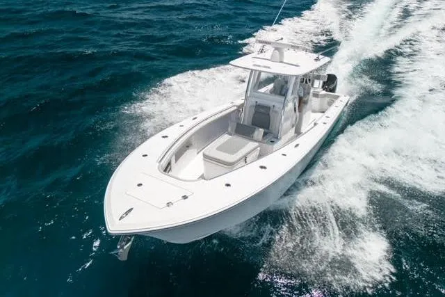 The Image of 2026 Front Runner 33 Center Console boat on trailer, parked outdoors on a cloudy day. - 0