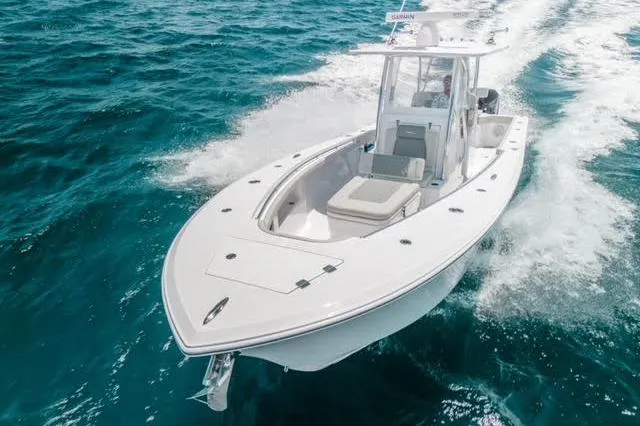 Slide: The Image of 2026 Front Runner 33 Center Console with dual outboard engines, docked on a cloudy day. - 3
