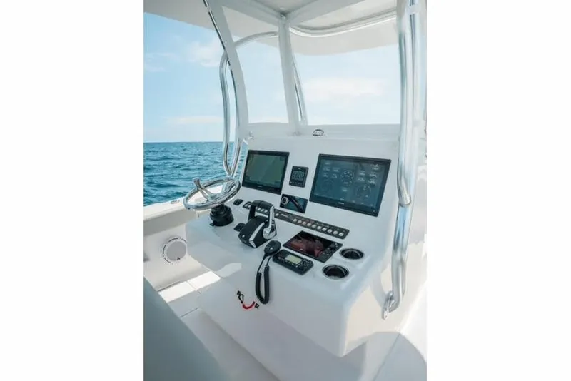 Slide: The Image of 2026 Front Runner 33 Center Console boat interior with white seating and controls. - 9