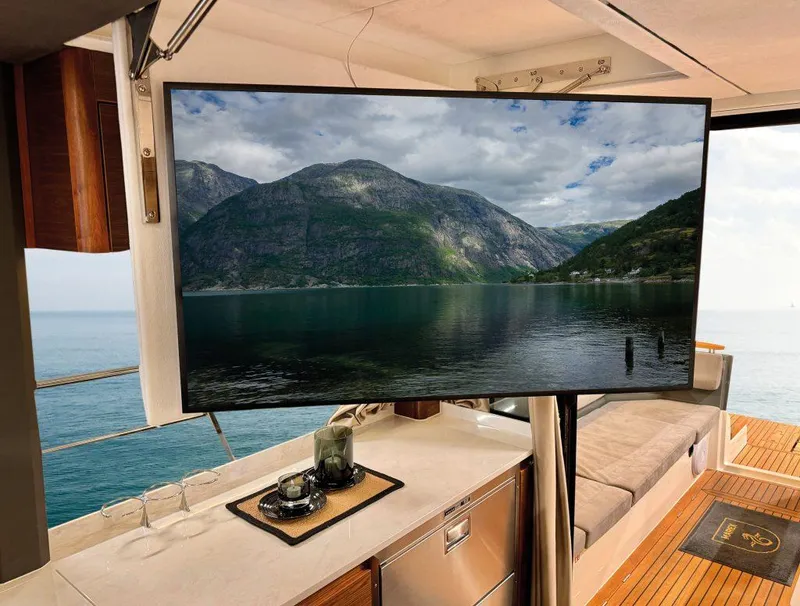 Slide: The Image of Luxury interior of 2025 Marex 440 Scandinavia yacht with scenic mountain view on screen. - 6