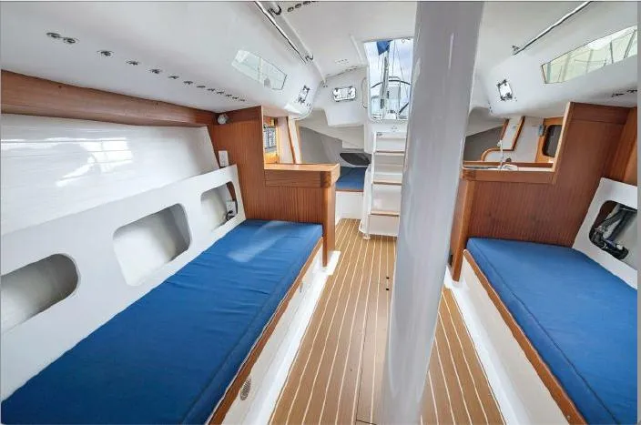 Slide: The Image of Interior of 2013 J Boats J/111 sailboat with blue cushions and wood accents. - 17