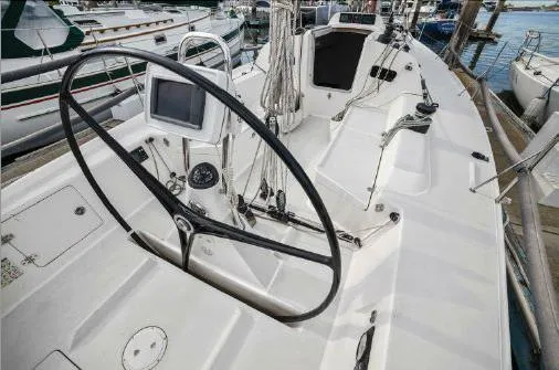 Slide: The Image of 2013 J Boats J/111 sailboat cockpit with steering wheel and navigation equipment. - 4