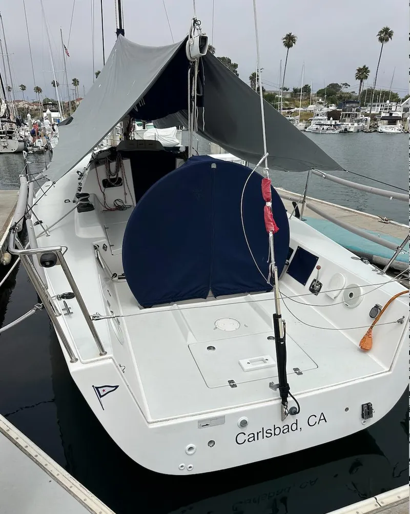Slide: The Image of 2013 J Boats J/111 sailboat docked in Carlsbad, CA marina with canopy. - 8