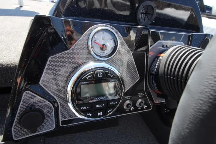 Slide: The Image of Dashboard of 2025 Lund 1875 Pro-V Bass XS boat with audio controls and gauge. - 2