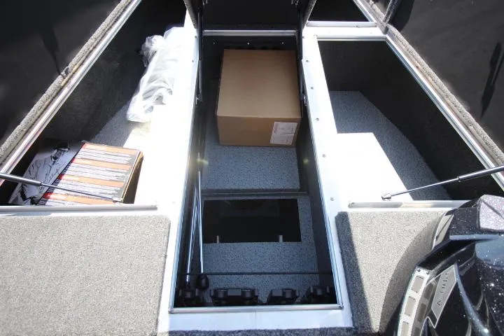 Slide: The Image of 2025 Lund 1875 Pro-V Bass XS boat storage compartments with gear and box. - 3
