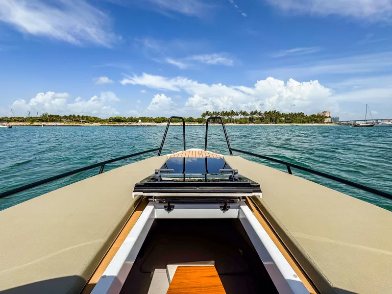 Slide: The Image of 2024 XO Boats EXPLR 10S Plus cruising on a sunny day with scenic island view. - 11