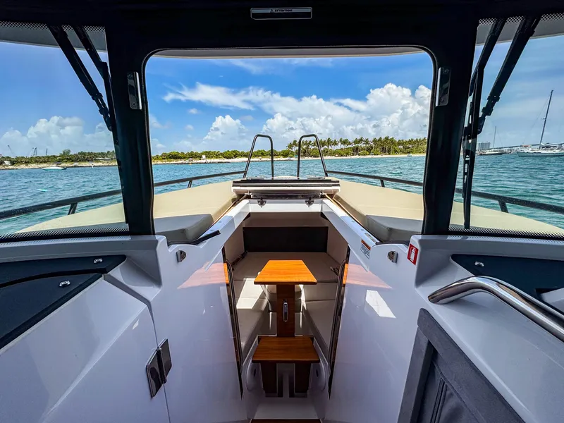 Slide: The Image of 2024 XO Boats EXPLR 10S Plus interior with ocean view and seating area. - 12