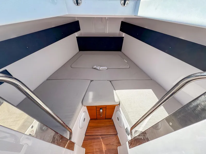 Slide: The Image of 2024 XO Boats EXPLR 10S Plus interior cabin with cushioned seating and wooden flooring. - 14