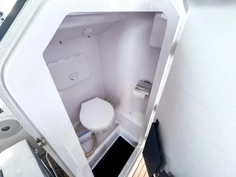 Slide: The Image of Compact bathroom in 2024 XO Boats EXPLR 10S Plus, featuring a modern toilet and sleek design. - 16