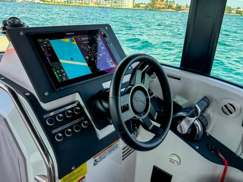 Slide: The Image of 2024 XO Boats EXPLR 10S Plus cockpit with navigation display and steering wheel. - 21