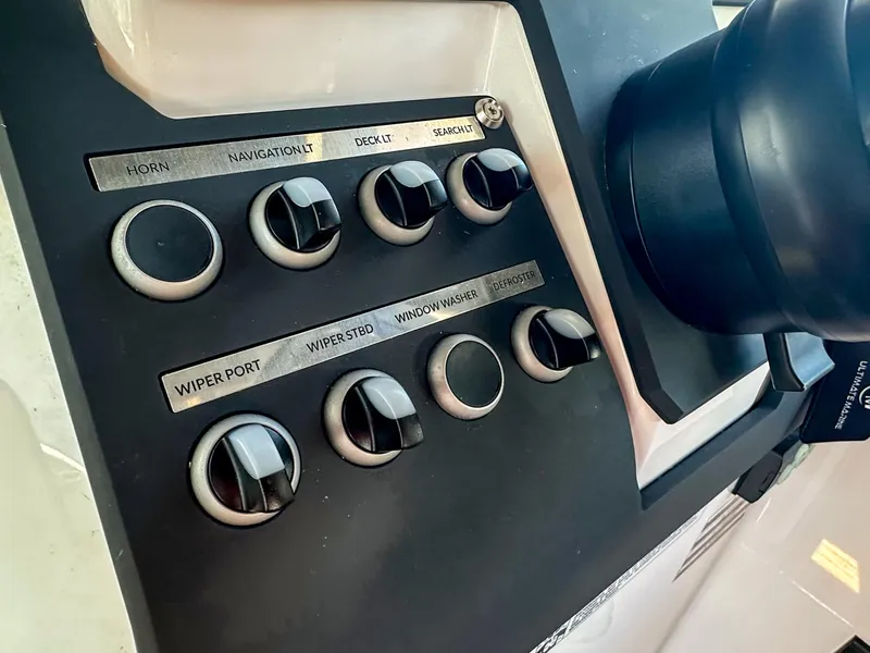 Slide: The Image of Control panel of 2024 XO Boats EXPLR 10 Sport Plus, featuring various switches and knobs. - 23