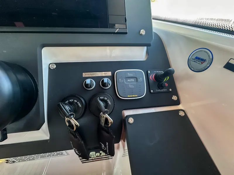 Slide: The Image of Control panel of 2024 XO Boats EXPLR 10 Sport Plus with ignition keys and switches. - 24