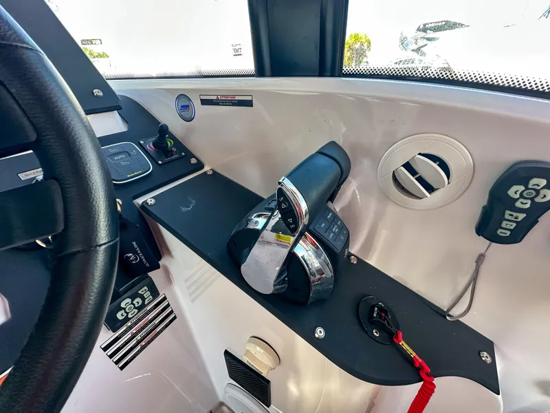 Slide: The Image of 2024 XO Boats EXPLR 10 Sport Plus dashboard with controls and steering wheel. - 26