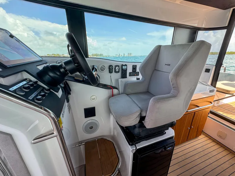 Slide: The Image of Helm of 2024 XO Boats EXPLR 10S Plus with modern controls and comfortable seating. - 27