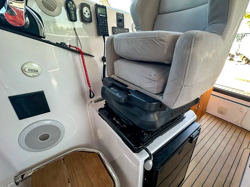 Slide: The Image of 2024 XO Boats EXPLR 10 Sport Plus interior with captain's chair and control panel. - 28