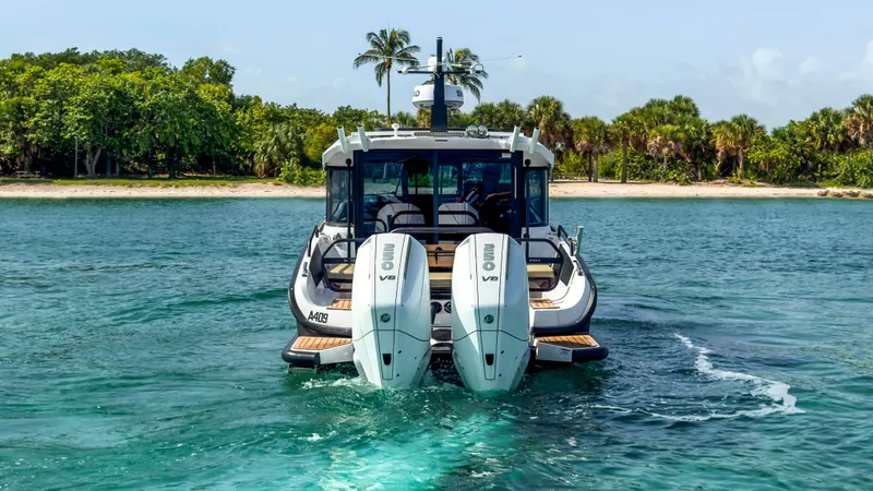 Slide: The Image of 2024 XO Boats EXPLR 10S Plus cruising near a tropical shoreline. - 4