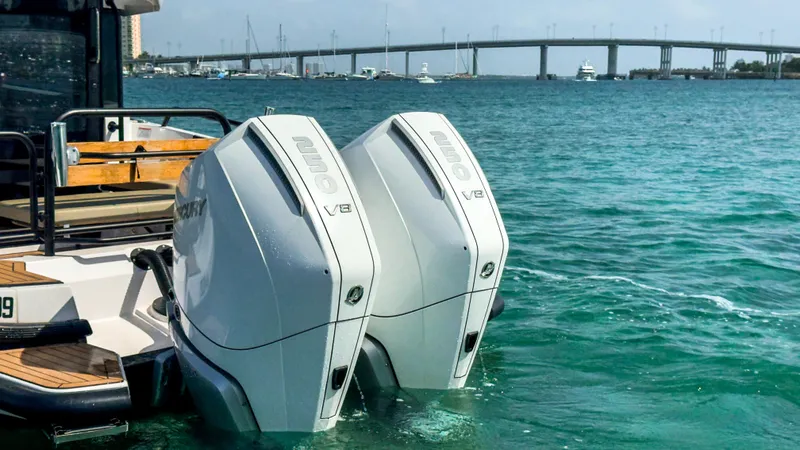 Slide: The Image of 2024 XO Boats EXPLR 10S Plus with dual Mercury V8 engines on the water. - 6