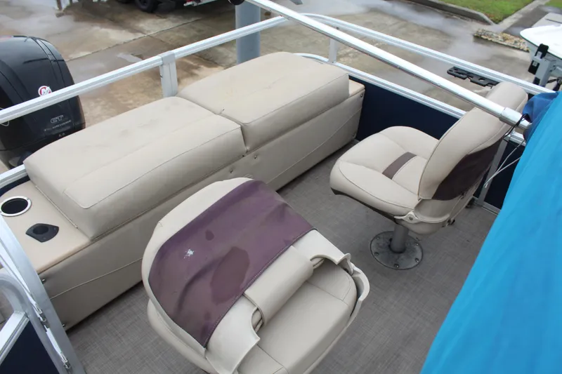 Slide: The Image of 2019 Sun Tracker Fishin' Barge 22 DLX interior with cushioned seating and fishing chairs. - 11