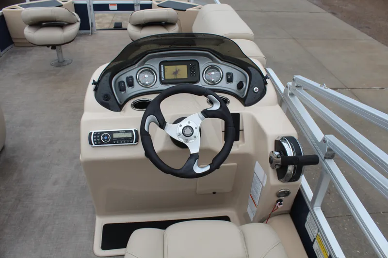 Slide: The Image of 2019 Sun Tracker Fishin' Barge 22 DLX dashboard with steering wheel and control panel. - 13