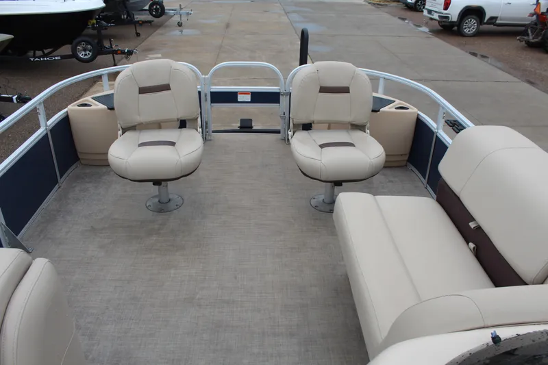 Slide: The Image of 2019 Sun Tracker Fishin' Barge 22 DLX interior with beige seating and spacious layout. - 14
