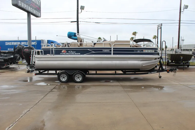 Slide: The Image of 2019 Sun Tracker Fishin' Barge 22 DLX pontoon boat on trailer at dealership. - 4