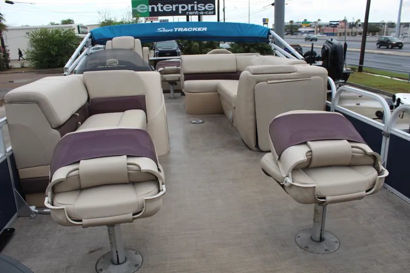 Slide: The Image of 2019 Sun Tracker Fishin' Barge 22 DLX interior with beige seating and open deck layout. - 9