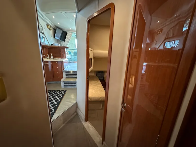Slide: The Image of Interior of a 1999 Sea Ray 400 Sedanbridge yacht, featuring a cozy cabin and modern amenities. - 14