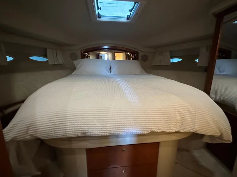 Slide: The Image of Luxurious bedroom interior of 1999 Sea Ray 400 Sedanbridge yacht with cozy bedding. - 15