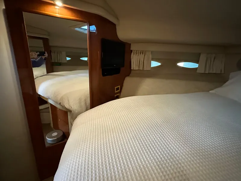 Slide: The Image of Interior of 1999 Sea Ray 400 Sedanbridge yacht bedroom with cozy bed and mirror. - 16
