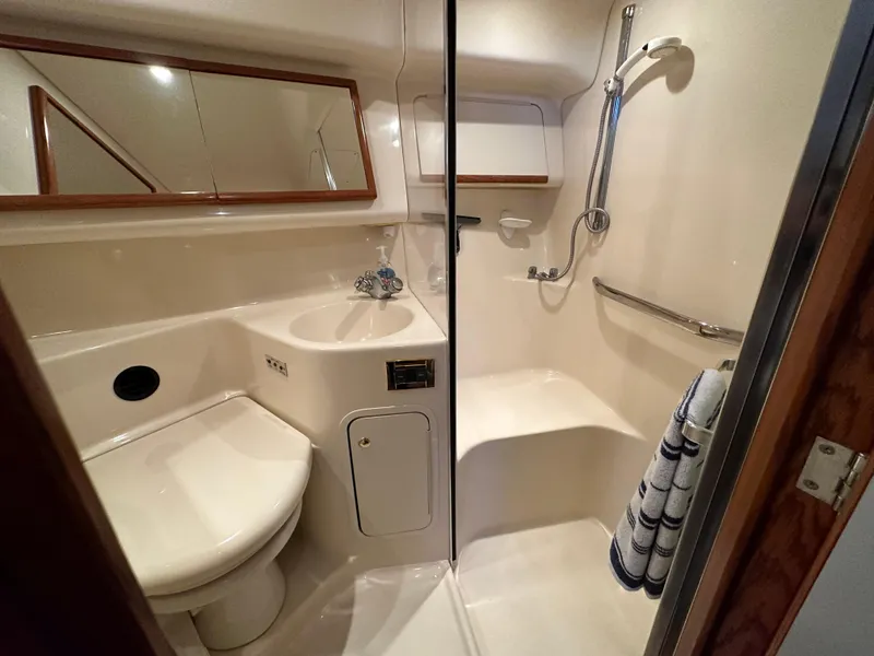 Slide: The Image of 1999 Sea Ray 400 Sedanbridge bathroom with shower, toilet, and sink. - 17