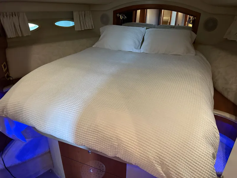 Slide: The Image of Cozy bedroom in 1999 Sea Ray 400 Sedanbridge yacht with white bedding and ambient lighting. - 18