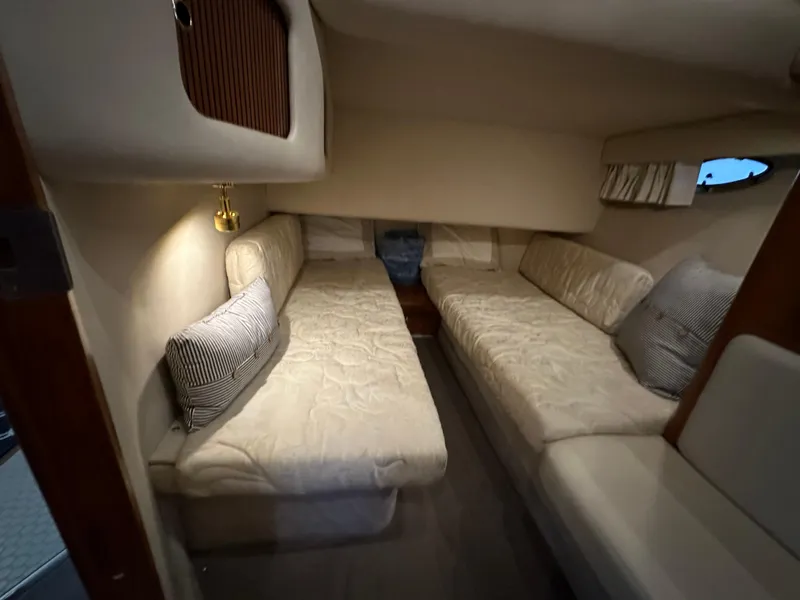 Slide: The Image of 1999 Sea Ray 400 Sedanbridge cabin with twin beds and cozy lighting. - 20