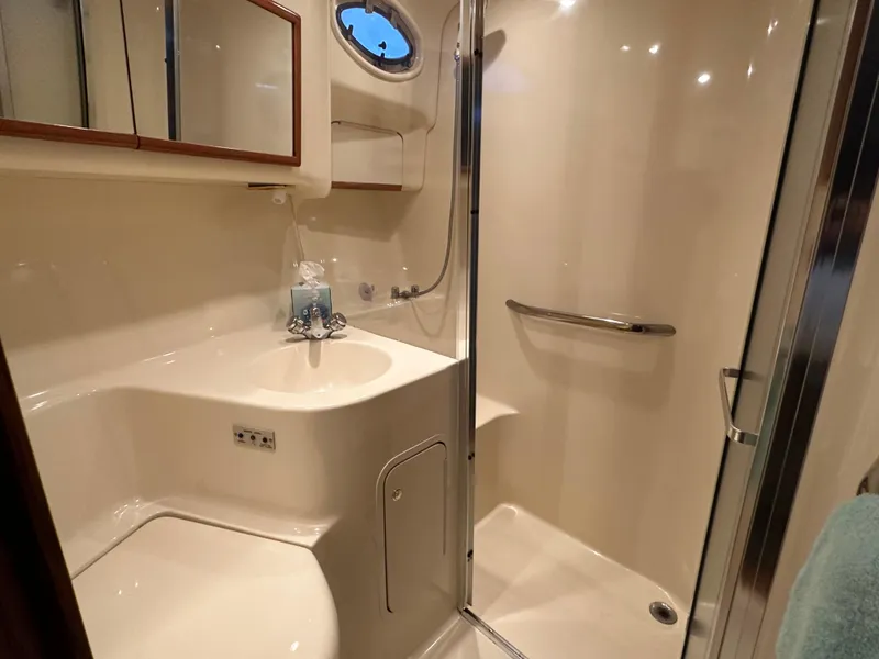 Slide: The Image of 1999 Sea Ray 400 Sedanbridge bathroom with shower, sink, and mirror cabinet. - 21