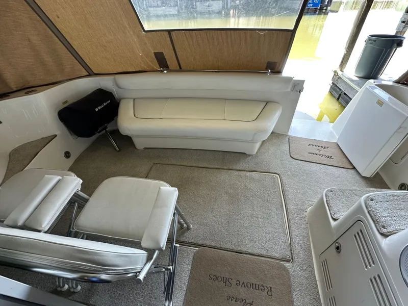 Slide: The Image of Interior of 1999 Sea Ray 400 Sedanbridge with seating and carpeted flooring. - 22