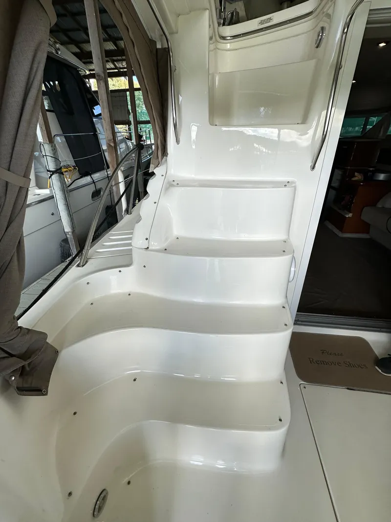 Slide: The Image of Staircase on a 1999 Sea Ray 400 Sedanbridge yacht, leading to the upper deck. - 23
