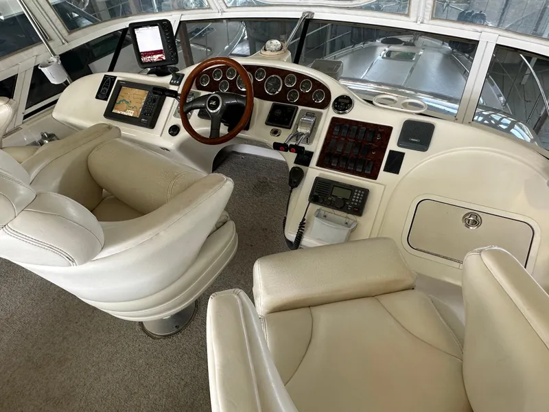 Slide: The Image of 1999 Sea Ray 400 Sedanbridge helm with leather seats and navigation controls. - 24