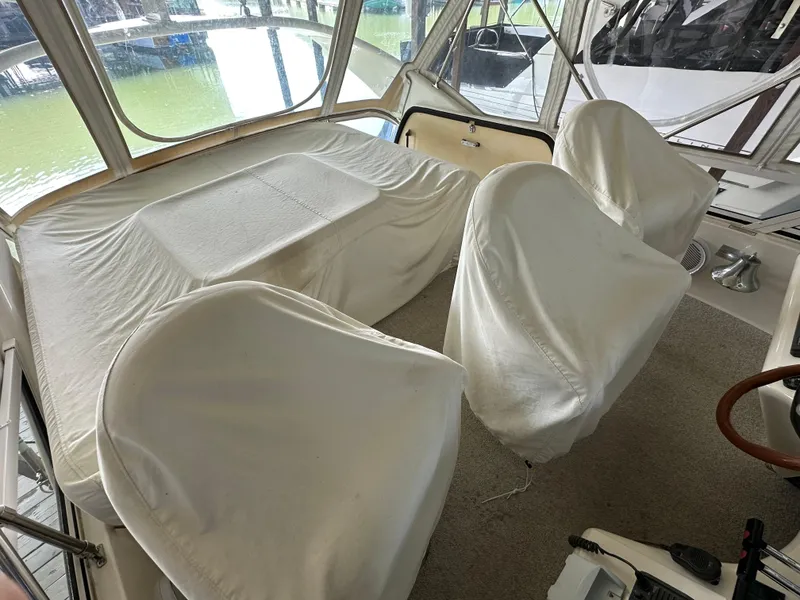 Slide: The Image of 1999 Sea Ray 400 Sedanbridge interior with covered seating and table. - 30