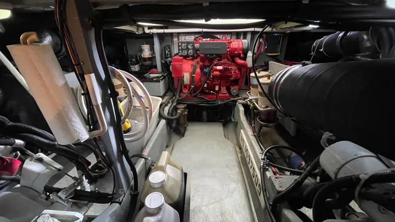 Slide: The Image of Engine room of a 1999 Sea Ray 400 Sedanbridge with visible machinery and equipment. - 31