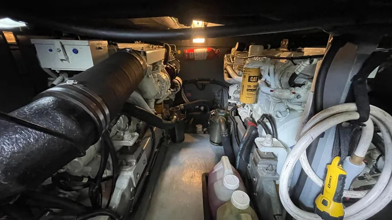 Slide: The Image of Engine room of a 1999 Sea Ray 400 Sedanbridge, showcasing mechanical components and equipment. - 32