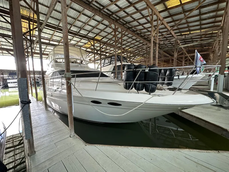 Slide: The Image of 1999 Sea Ray 400 Sedanbridge yacht docked in a covered marina. - 37