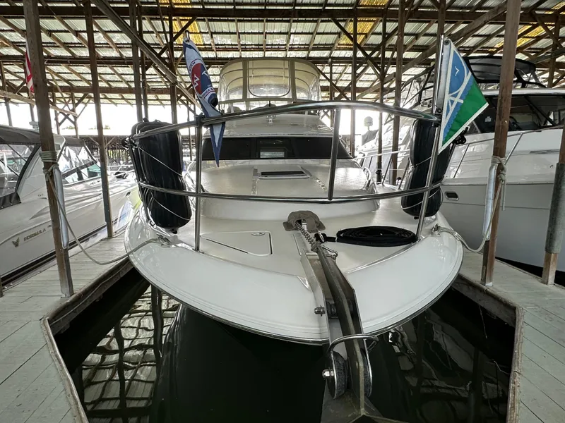 Slide: The Image of 1999 Sea Ray 400 Sedanbridge yacht docked in a covered marina. - 38