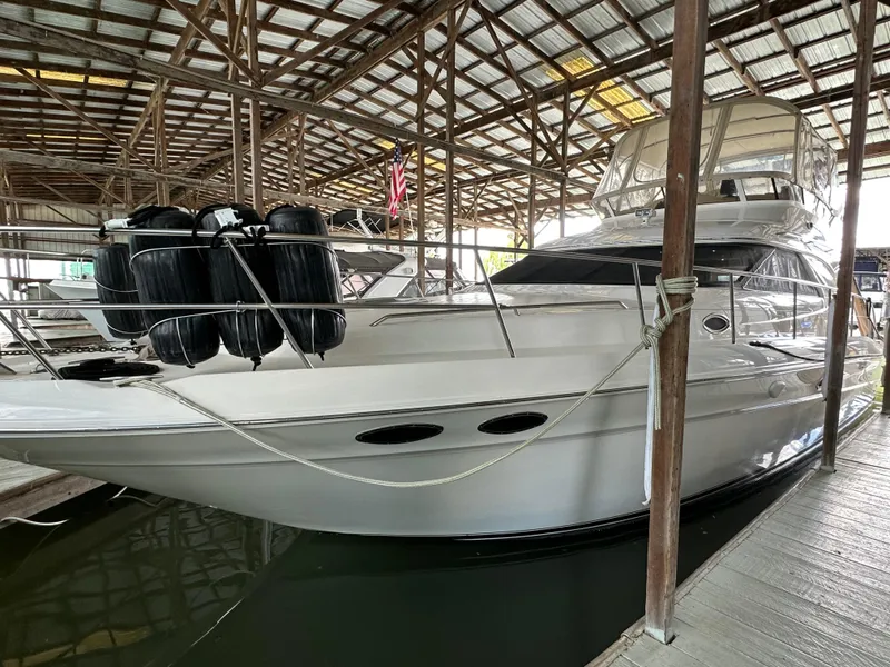 Slide: The Image of 1999 Sea Ray 400 Sedanbridge yacht docked in a covered marina. - 39