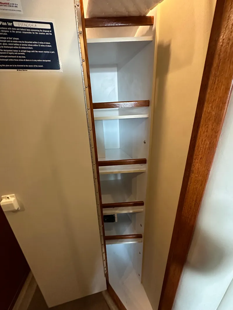 Slide: The Image of 1999 Sea Ray 400 Sedanbridge interior shelving with wooden trim. - 8