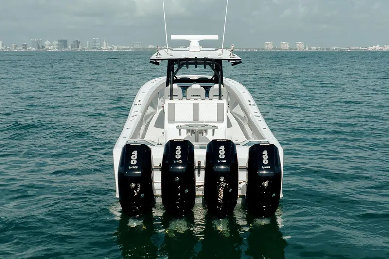 Slide: The Image of 2026 Front Runner 39 Center Console boat, blue canopy, white seating, palm trees, clear sky. - 13